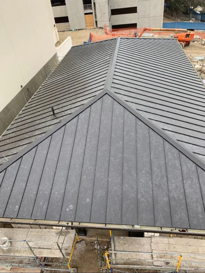 Commercial metal roof construction with crane equipment in Fort Shawnee