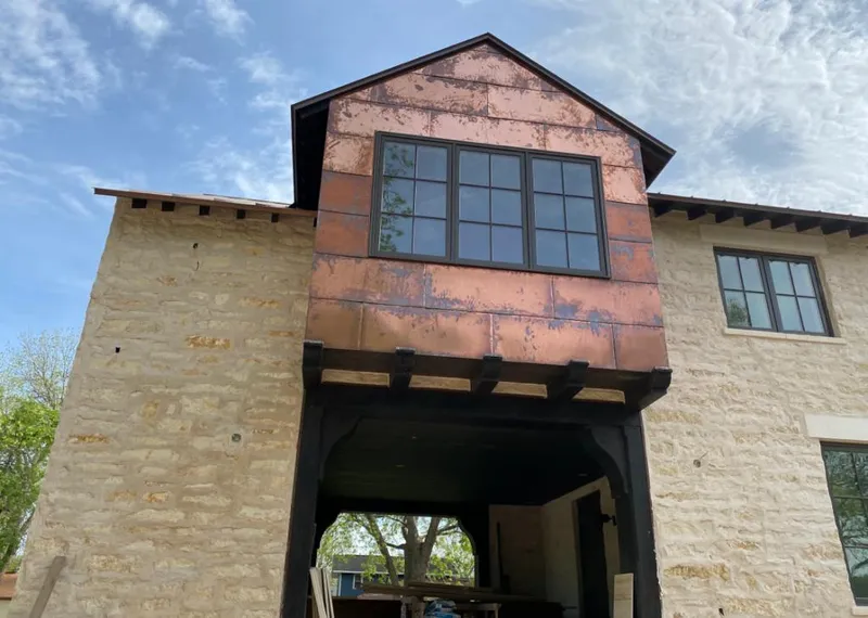 Copper metal panel facade on a stone building for Skylight Installation in Fort Shawnee
